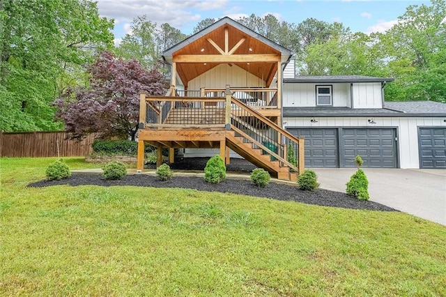 110 W Putnam Ferry Rd, Woodstock, GA 30189 - back of house featuring board and batten siding, stairway, driveway, roof with shingles, and a garage