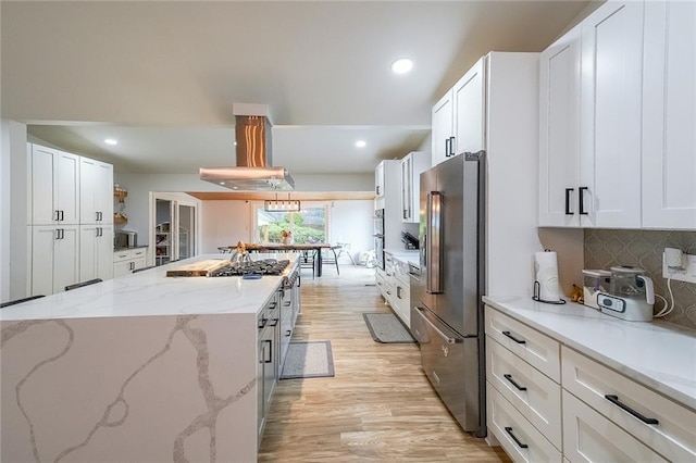 110 W Putnam Ferry Rd, Woodstock, GA 30189 - kitchen with appliances with stainless steel finishes, light wood-type flooring, island exhaust hood, white cabinets, and recessed lighting