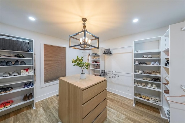 110 W Putnam Ferry Rd, Woodstock, GA 30189 - walk in closet with a chandelier and light wood finished floors