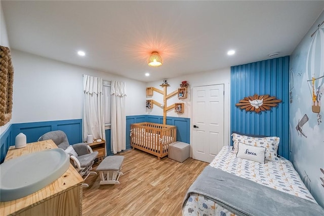 110 W Putnam Ferry Rd, Woodstock, GA 30189 - bedroom with light wood-style floors, wainscoting, and recessed lighting