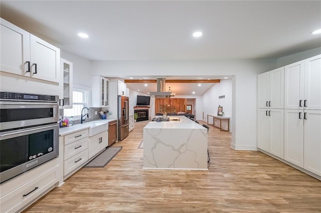 110 W Putnam Ferry Rd, Woodstock, GA 30189 - kitchen with a sink, stainless steel appliances, island range hood, white cabinets, and glass insert cabinets