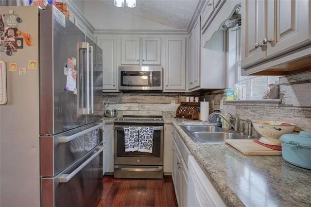 kitchen featuring sink, a textured ceiling, white cabinetry, and stainless steel appliances