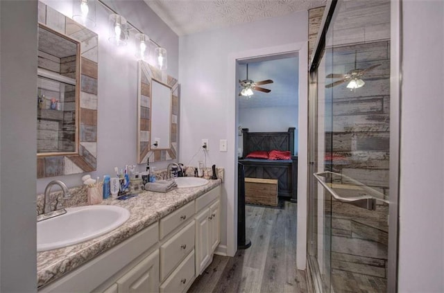 bathroom featuring hardwood / wood-style flooring, a textured ceiling, walk in shower, and ceiling fan