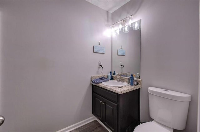 bathroom featuring toilet and vanity