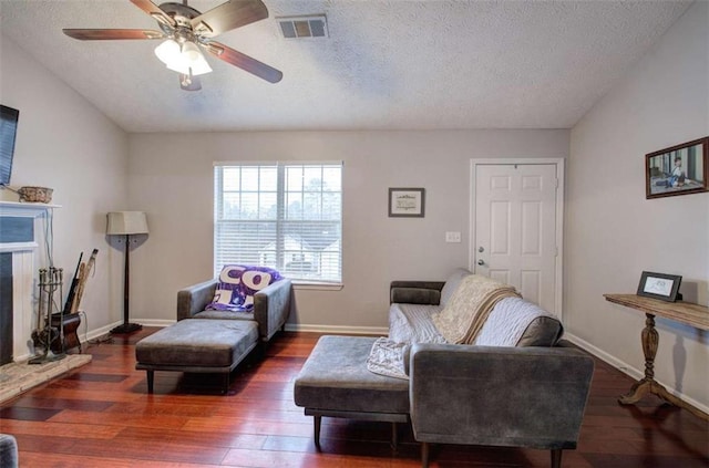 sitting room with a textured ceiling, ceiling fan, and dark hardwood / wood-style flooring