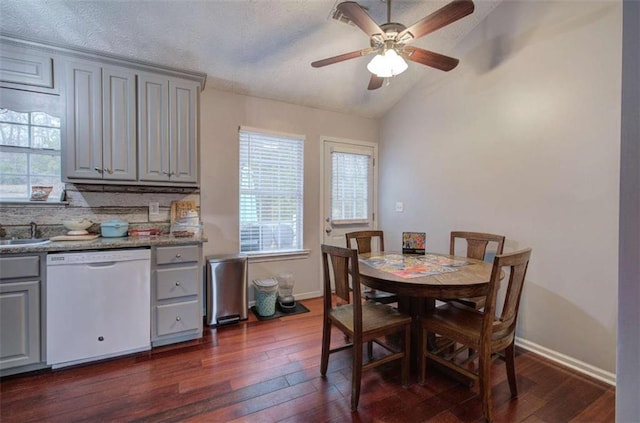 dining area with ceiling fan, dark wood-type flooring, a textured ceiling, and lofted ceiling