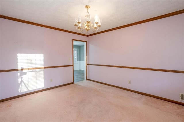 spare room featuring crown molding, a chandelier, and light carpet