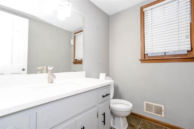 bathroom featuring vanity, tile patterned floors, and toilet