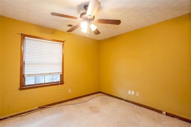 empty room featuring carpet flooring and ceiling fan