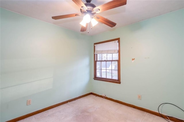 spare room featuring light carpet and ceiling fan