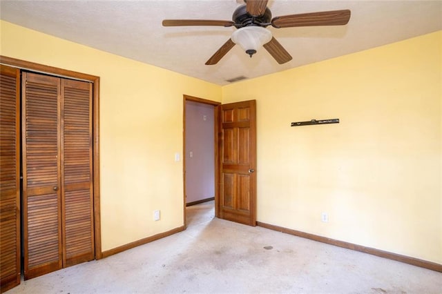 unfurnished bedroom featuring light carpet, ceiling fan, and a closet