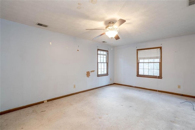 carpeted empty room with ceiling fan