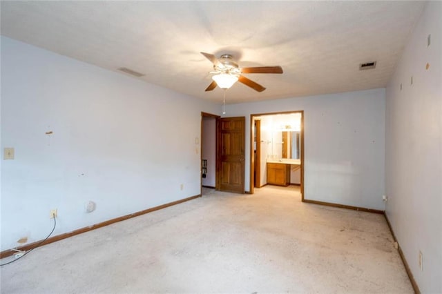 interior space featuring ensuite bath and ceiling fan