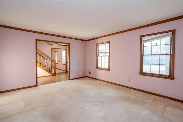 unfurnished room with ornamental molding and light carpet