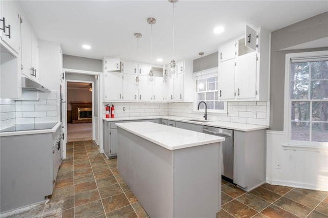 kitchen with dishwasher, a center island, pendant lighting, and white cabinets