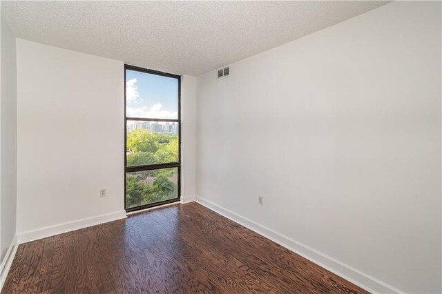 375 Ralph Mcgill Blvd NE Unit 807, Atlanta, GA 30312 - unfurnished room featuring visible vents, expansive windows, a textured ceiling, dark wood-style floors, and baseboards