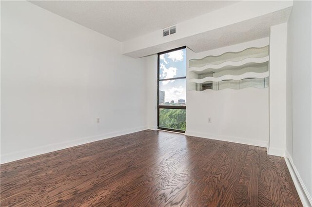 375 Ralph Mcgill Blvd NE Unit 807, Atlanta, GA 30312 - unfurnished room featuring visible vents, baseboards, and wood finished floors