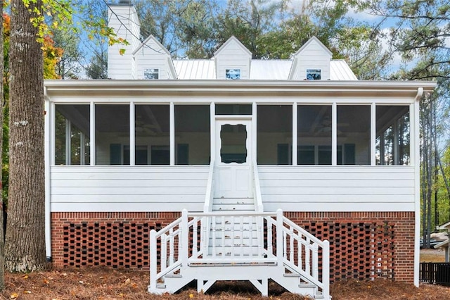 view of front of home featuring a sunroom