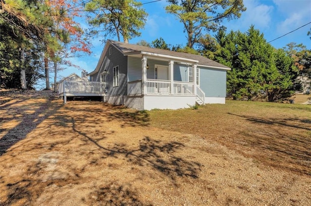 exterior space with covered porch and a front lawn