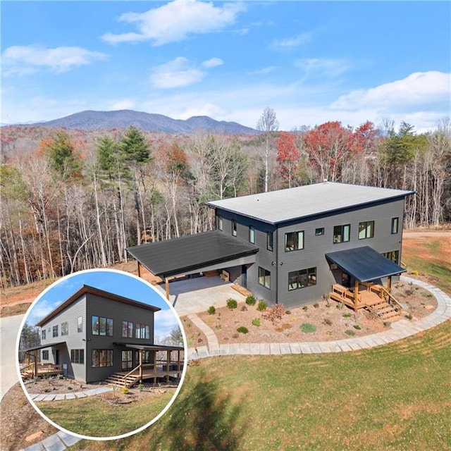 exterior space with a deck with mountain view and a yard