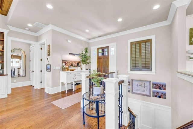 entrance foyer featuring light wood-type flooring and ornamental molding