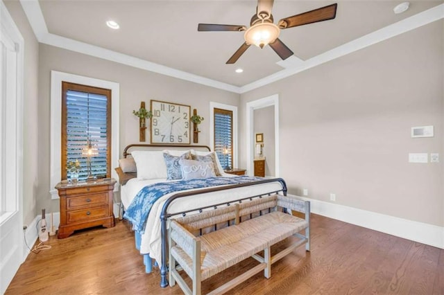 bedroom with ceiling fan, ornamental molding, and hardwood / wood-style flooring