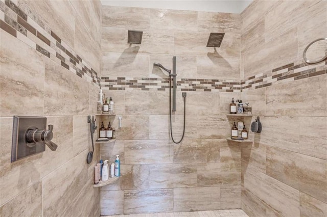 bathroom with a tile shower