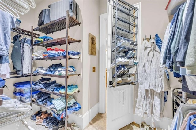 walk in closet with carpet