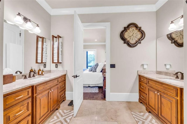 bathroom featuring tile patterned flooring, vanity, and crown molding