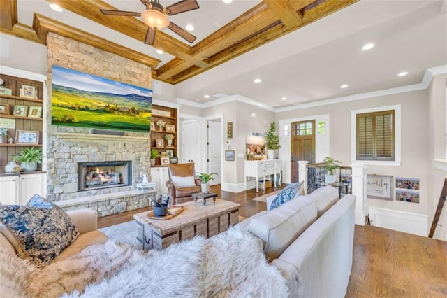 living room with beamed ceiling, wood-type flooring, crown molding, and coffered ceiling