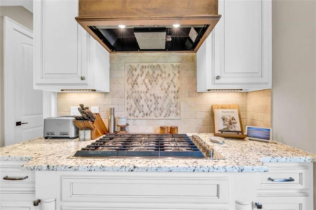 kitchen with white cabinets, premium range hood, and stainless steel gas stovetop