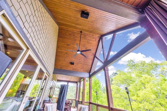 unfurnished sunroom with vaulted ceiling, ceiling fan, and wooden ceiling