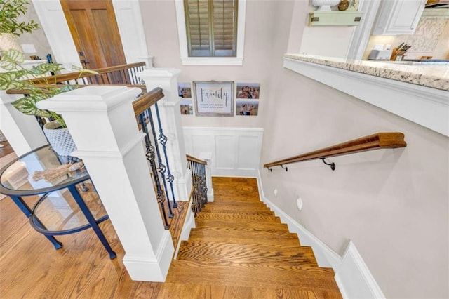 staircase with hardwood / wood-style flooring