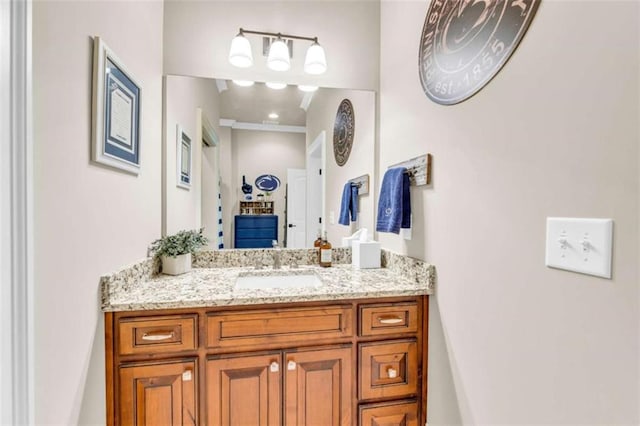 bathroom featuring vanity and ornamental molding