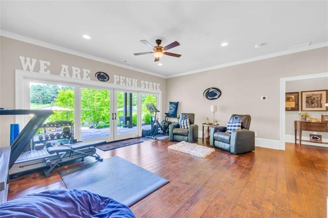 workout area featuring hardwood / wood-style flooring, ceiling fan, ornamental molding, and french doors