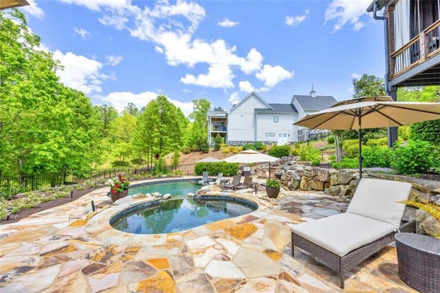 view of swimming pool with a patio area and an in ground hot tub