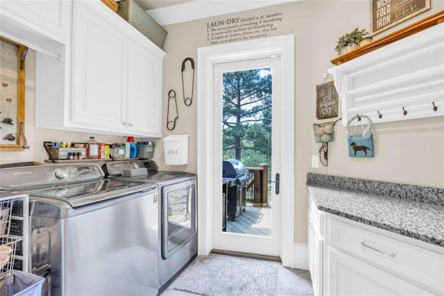 laundry room featuring cabinets and washing machine and clothes dryer