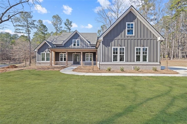 modern inspired farmhouse featuring brick siding, board and batten siding, a standing seam roof, metal roof, and a front lawn