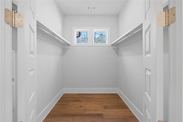 spacious closet with visible vents and wood finished floors