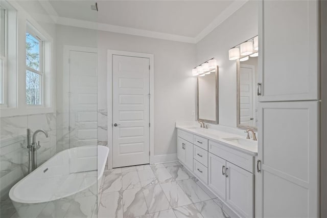 full bath with a sink, marble finish floor, ornamental molding, a soaking tub, and double vanity