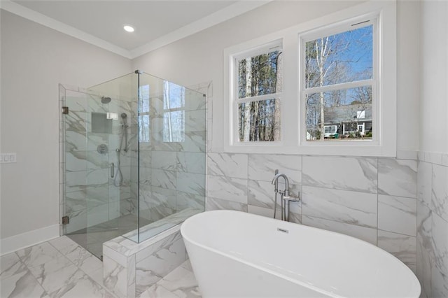 bathroom with marble finish floor, a marble finish shower, recessed lighting, ornamental molding, and a freestanding tub