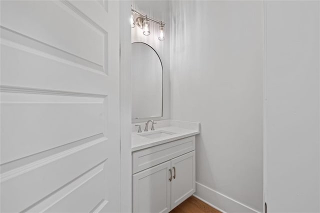 bathroom featuring baseboards and vanity