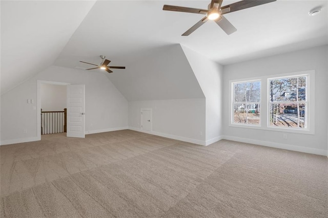 bonus room with vaulted ceiling, carpet flooring, and baseboards