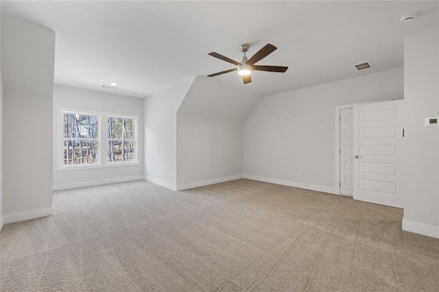 additional living space with ceiling fan, lofted ceiling, carpet floors, visible vents, and baseboards