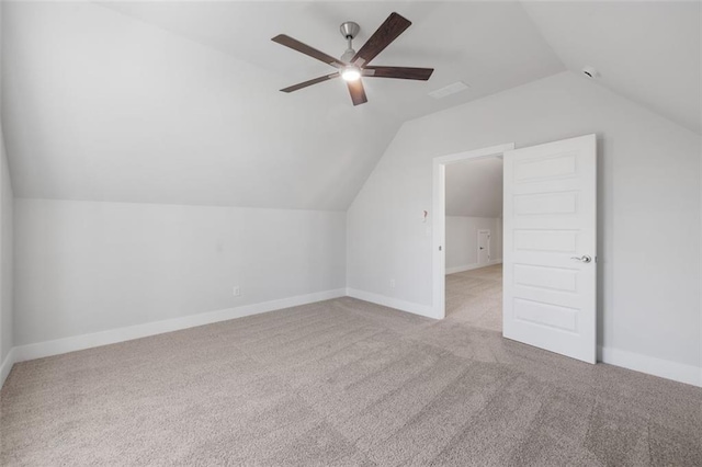 bonus room featuring lofted ceiling, baseboards, ceiling fan, and carpet