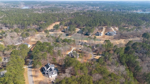 birds eye view of property with a view of trees