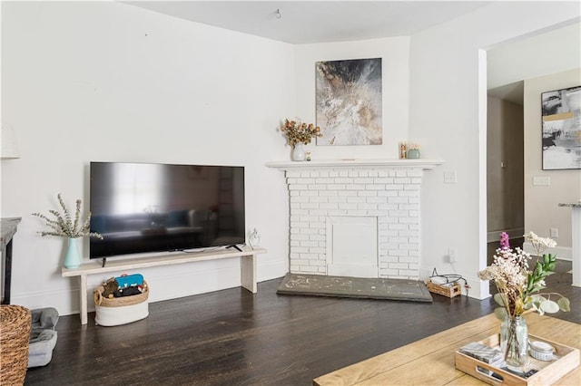 820 Elbert St SW, Atlanta, GA 30310 - living area with a brick fireplace, wood finished floors, and baseboards