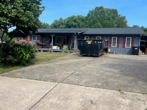 single story home with board and batten siding and driveway