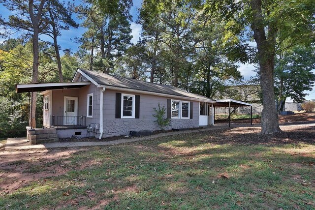 view of side of property with a carport