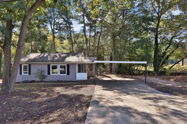 ranch-style house featuring a carport